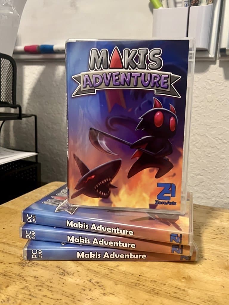 A stack of finished Maki's Adventure retail DVD cases on a desk