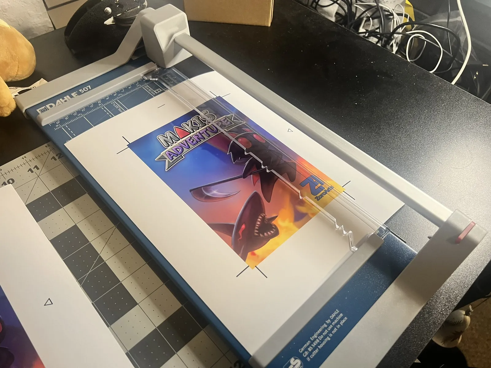 A Maki's Adventure cover sheet loaded on a Dahle 507 rotary trimmer, ready for its first cut.